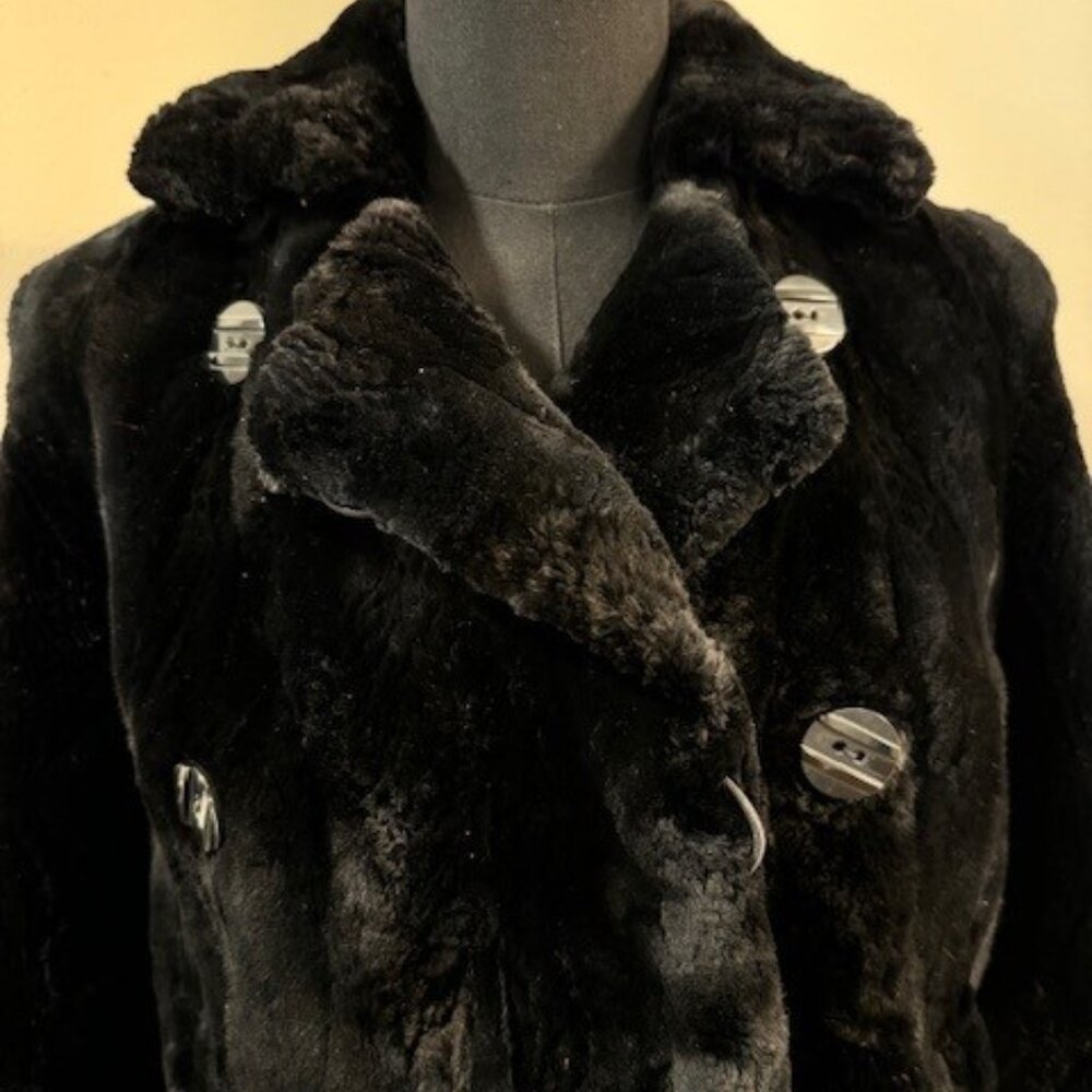 Black Double Breasted Mink jacket never worn.  Would fit sizes 4 and 6.